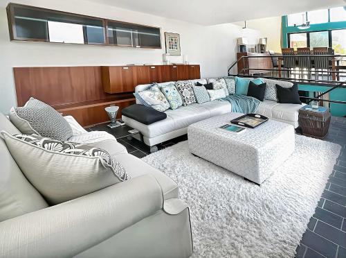 a living room with two couches and a table at Villa Vista Oceanfront 4BR - Infinity Pool - Views in Enighed