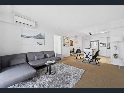a living room with a couch and a table at 2-bedroom Apartment in Brisbane
