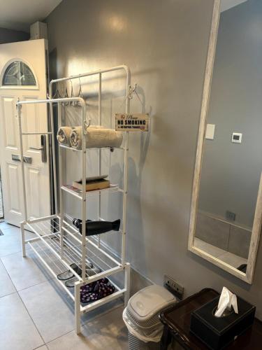 a bathroom with a towel rack next to a toilet at The Garden Studio - Private, Modern, Cozy, Ensuite in a Quiet Area in Luton