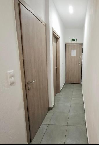 a hallway with two doors and a tile floor at HomeBak Hospitality in Xanthi