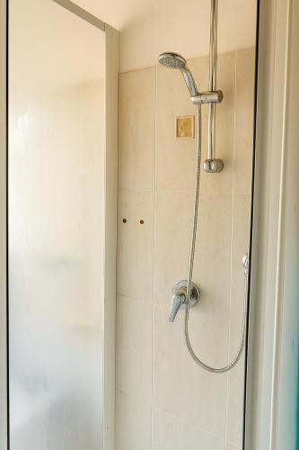 a shower with a shower head in a bathroom at Casa Boara in Ferrara