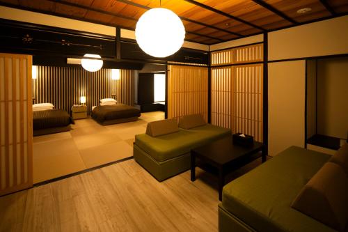 a living room with a couch and a bed at Hotel Clio Court Hakata in Fukuoka