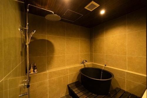 a bathroom with a bath tub and a shower at Hotel Clio Court Hakata in Fukuoka
