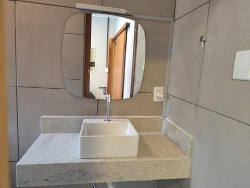 a bathroom with a sink and a mirror at Cozy house in the First Winery of São Roque in São Roque