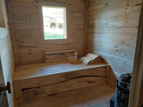 a wooden sauna with a bench in a cabin at Cicha Strzała 