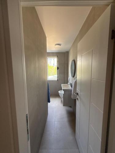 a bathroom with a white toilet and a sink at Estel Apartament in Tirana