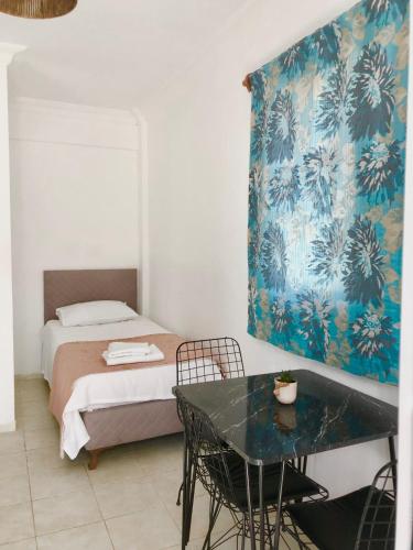 a bedroom with a bed and a table with chairs at Deka apartments 5 in Fethiye