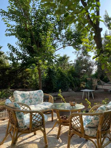 a patio with three chairs and a table and a table at Deka apartments 5 in Fethiye
