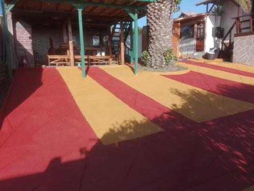 a shadow of a tree on a colorful sidewalk at Cabaña recinto Super vista, WIFI con terraza1 in San Antonio
