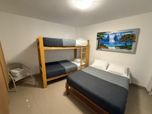 a bedroom with two bunk beds and a bed at SG Paracas Hostel in Paracas