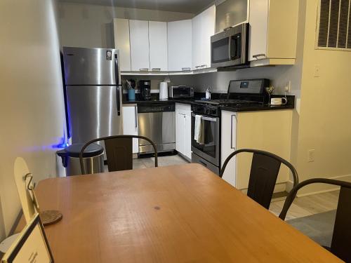 a kitchen with a table and chairs and a refrigerator at Charming 2BD1BA in Hip Area - Near Metro in Washington, D.C.