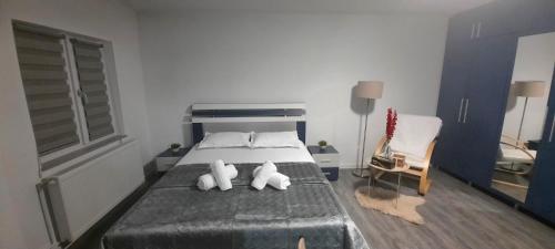 a bedroom with a bed with two stuffed animals on it at Garsoniera Mihaela in Craiova