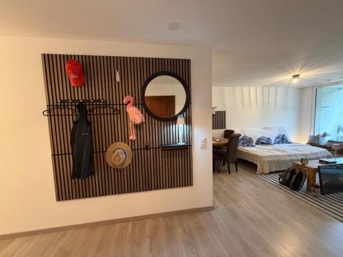 Una habitación con una cama y un espejo en la pared. en Relax Paradise in Bad Zurzach, en Bad Zurzach