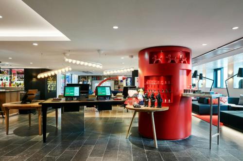 a store with a red column in the middle of a room at citizenM Paris Champs-Élysées in Paris
