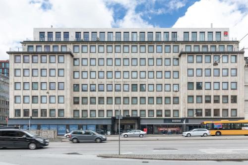 a large building with cars parked in front of it at citizenM Copenhagen Radhuspladsen in Copenhagen