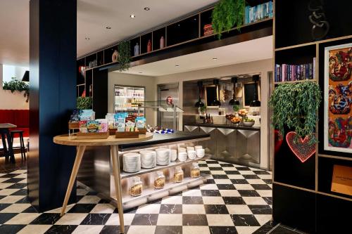 a pastry shop with a table and a counter at citizenM London Victoria Station in London