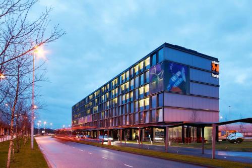 a building with a sign on the side of it at citizenM Schiphol Airport in Schiphol