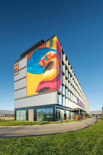 a building with a large painting of a dog on it at citizenM Schiphol Airport in Schiphol