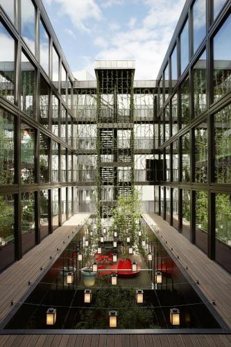 a rendering of a building with a garden in the middle at citizenM London Bankside in London