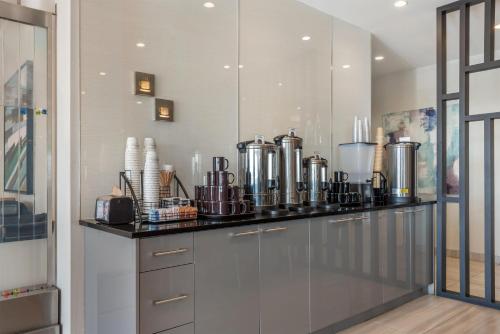 a kitchen with a counter with many appliances at Executive Residency by Best Western Calgary City View North in Calgary