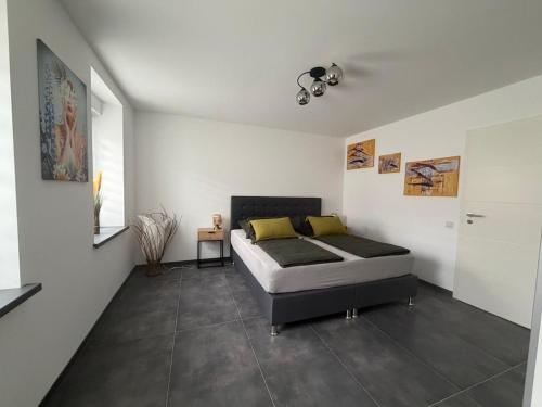 a bedroom with a bed in a white room at Mira Suites 1 in Schwalbach