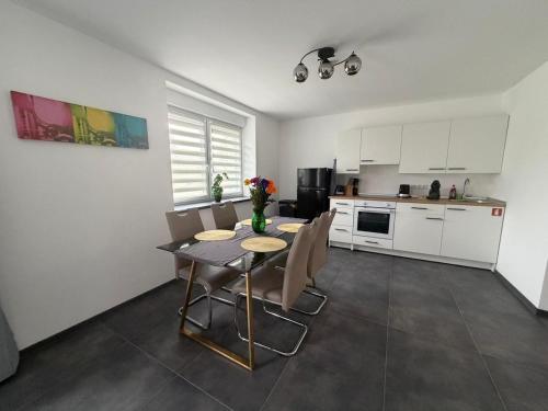 a kitchen with a table and chairs in a room at Mira Suites 1 in Schwalbach