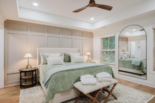 a bedroom with a large bed and a mirror at Lowcountry Landing! 3-story Townhouse in Old Town's Promenade in Bluffton