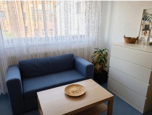 a living room with a blue couch and a coffee table at Studio 22 - Mulhouse Centre in Mulhouse