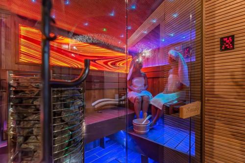a room with a bathroom with two people sitting in a sink at Rezidence Znojmo SPA Privat wellness in Znojmo