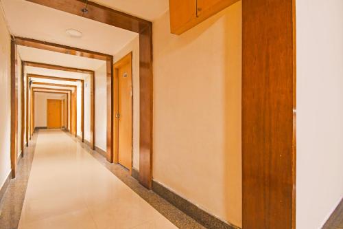 a corridor of a building with wooden doors and a long hallway at Townhouse Hill Cart Road Siliguri in Siliguri