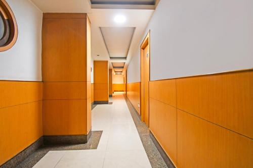 a corridor of a hospital hallway with wooden walls at Townhouse Hill Cart Road Siliguri in Siliguri