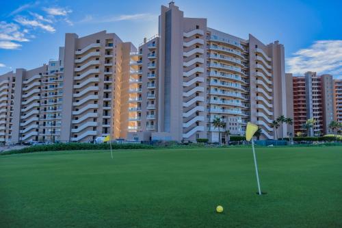 two golf balls on a green in front of buildings at 1BR 1BA Ocean View Las Palomas Phase 1 Bld Ruby in Puerto Peñasco