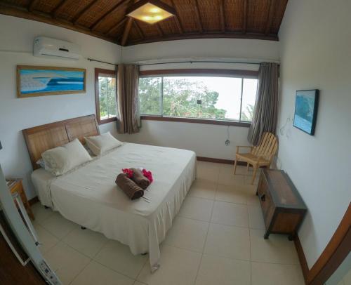 Ένα ή περισσότερα κρεβάτια σε δωμάτιο στο Sua família em praia privativa com conforto e tranquilidade