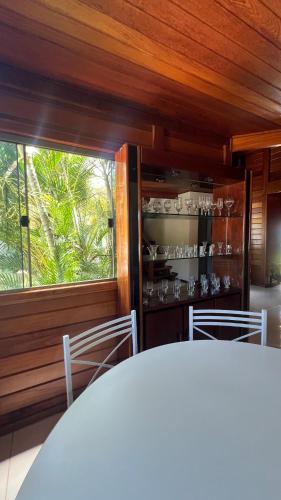 a dining room with a table and a window at Casa - Guarapari in Guarapari