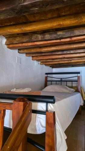 two bunk beds in a room with wooden ceilings at eleni's cozy appartment in Kástron