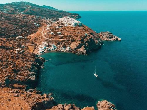an island with a boat in the water at eleni's cozy appartment in Kastron
