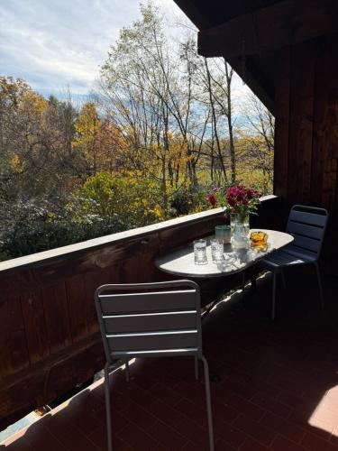 a table and chairs sitting on a porch with a view at Soleils Living I See & Berge I Starnberger See in Berg am Starnberger See