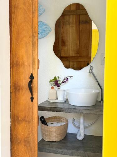 a bathroom with a sink and a mirror at Villa Tropicana in Saubara