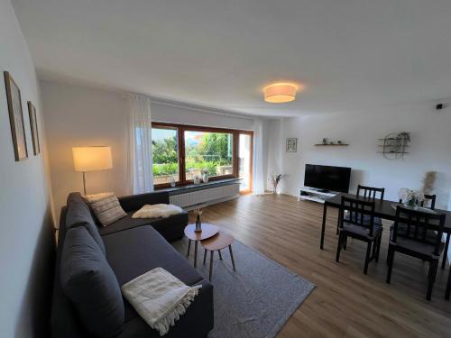 a living room with a couch and a table at Wohnglück Seifferer in Ravensburg