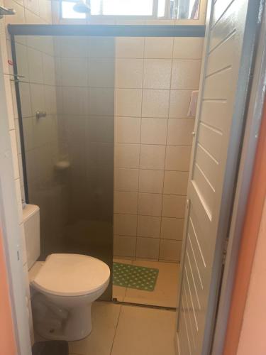 a small bathroom with a toilet and a shower at Lindo Nascer do Sol in Recife