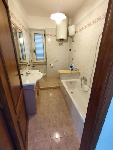 a bathroom with a tub and a sink and a bath tub at Guesthouse Matese in Piedimonte dʼAlife