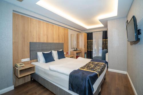 a hotel room with a large bed and a television at Hotel Martini in Istanbul
