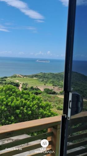 a view of the ocean from the window of a train at Refúgio Farol Ponta do Catalão - Imbituba/SC in Imbituba