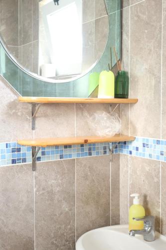 a bathroom with a sink and a mirror and a sink at The edge of the Atlantic 