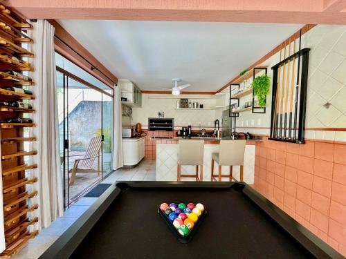 a pool table with balls on it in a kitchen at Casa Arborizada - Bairro João Paulo Norte da ilha in Florianópolis