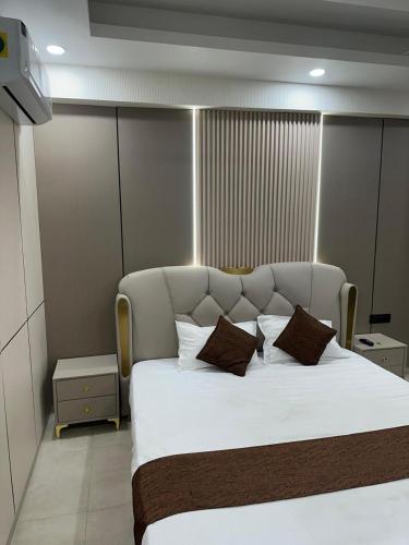 a bedroom with a large white bed with two pillows at Regal StayThe Perfect Blend of Luxury And Comfort in Nilmatha