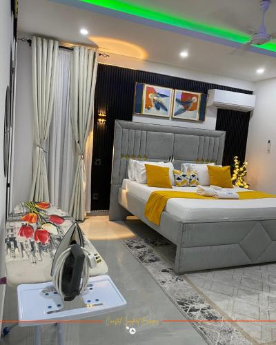 a bedroom with a king sized bed and a table at Coastal Gem 3BR, Pool, 5 Min Walk to Beach - Nyali in Nyali