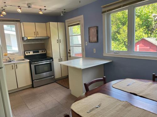 a kitchen with a counter and a table in it at Bright Private Room near Montreal Fast WiFi in Brossard