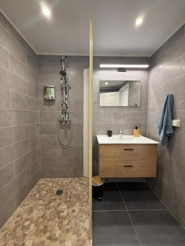 a bathroom with a sink and a shower at Cozy Beachside Studio with Beach Access & Pool in Marigot