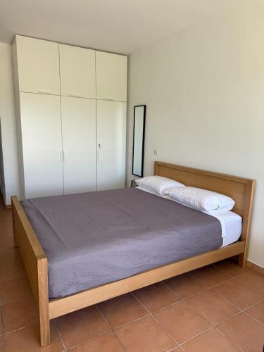 a bedroom with a large bed with white cabinets at Cozy Beachside Studio with Beach Access & Pool in Marigot
